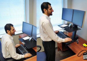 Businessman using Ergotron WorkFit 33-349-200 Sit-Stand Desk