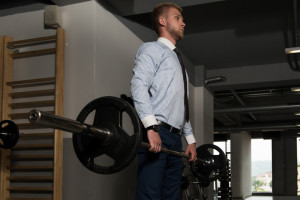 Businessman Doing Deadlifts